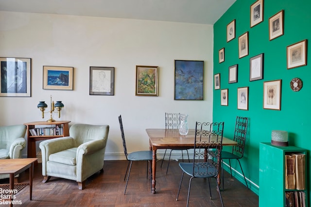 dining room featuring dark parquet flooring