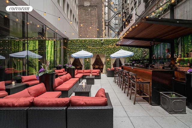 view of patio / terrace with outdoor dry bar and an outdoor living space