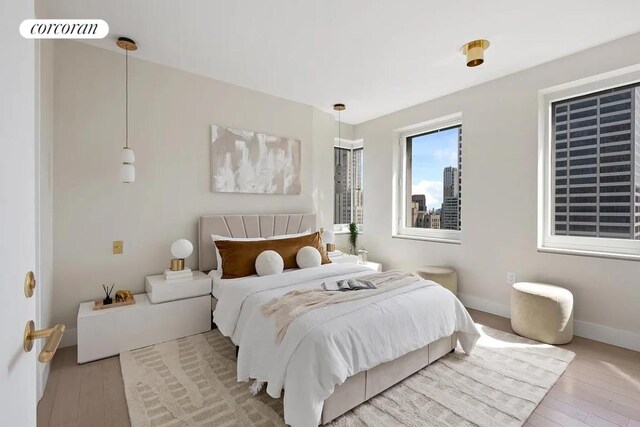 bedroom featuring baseboards, visible vents, and hardwood / wood-style floors