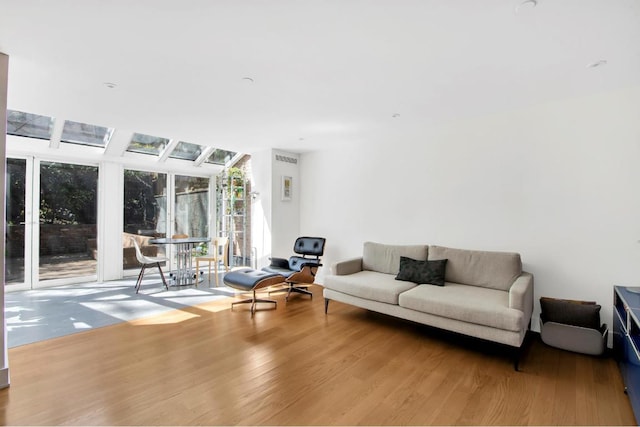 living room featuring vaulted ceiling and light wood-type flooring