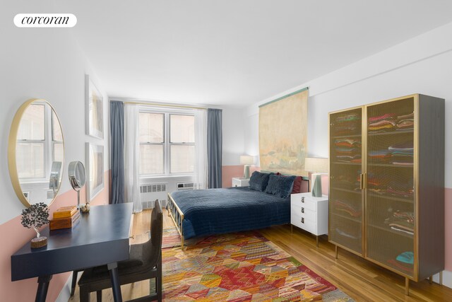 bedroom featuring visible vents and wood finished floors