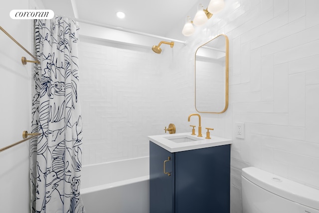 full bathroom featuring vanity, toilet, tile walls, and shower / tub combo