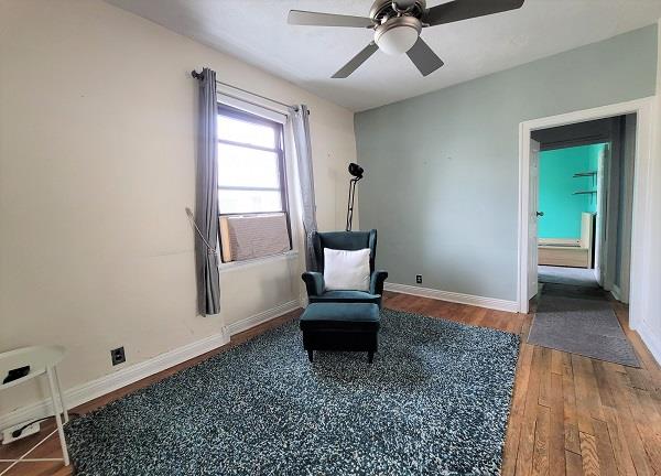 sitting room featuring hardwood / wood-style flooring and ceiling fan