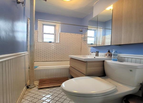 full bathroom featuring tiled shower / bath combo, vanity, plenty of natural light, and toilet