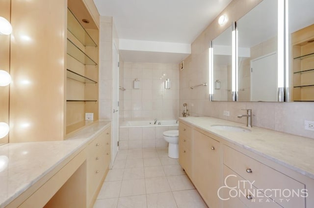 bathroom featuring tasteful backsplash, toilet, tiled shower / bath combo, vanity, and tile patterned floors