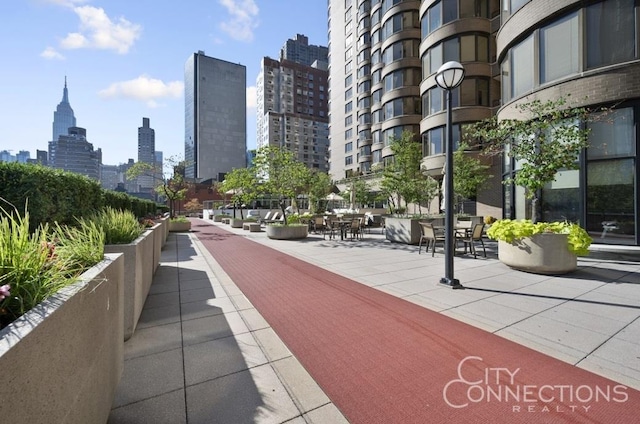 view of home's community featuring a patio area and a view of city