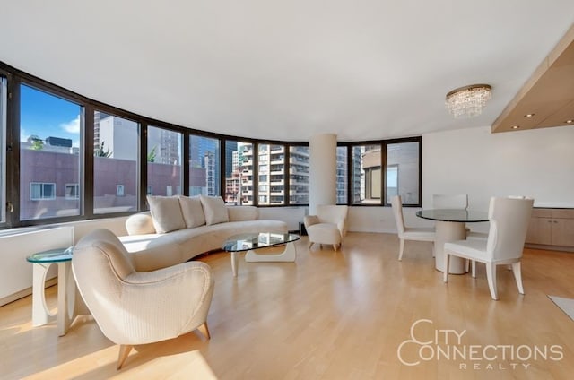 living area with an inviting chandelier and light wood-style floors