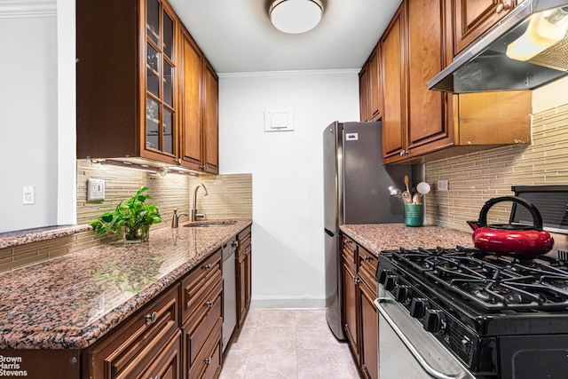 kitchen with sink, stone countertops, appliances with stainless steel finishes, ornamental molding, and decorative backsplash