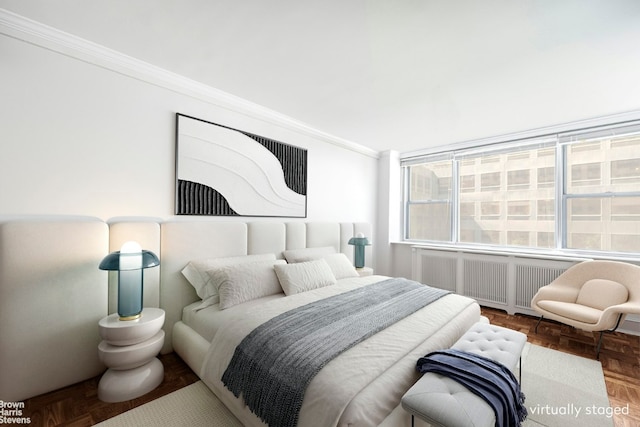 bedroom with parquet floors, crown molding, and radiator