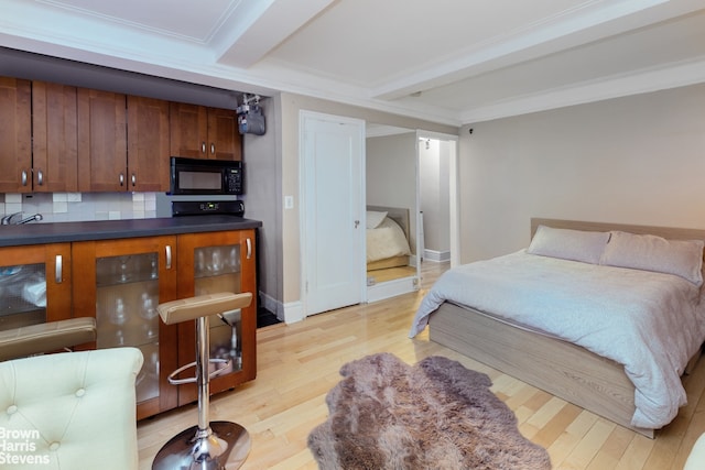 bedroom featuring ornamental molding, beam ceiling, and light hardwood / wood-style flooring