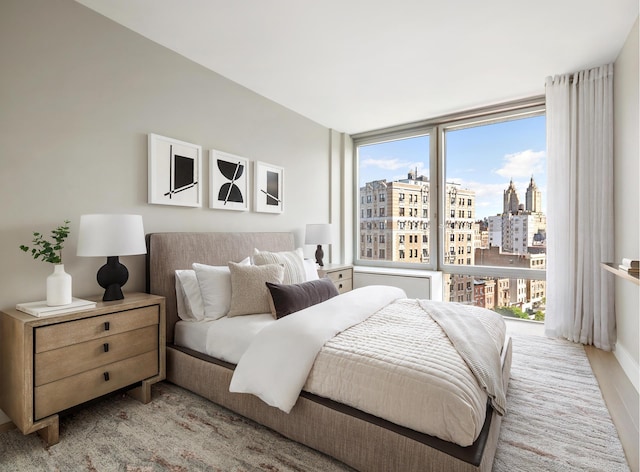 212 W 72nd St Unit 9J, New York City, NY 10023 - bedroom with a city view and wood finished floors