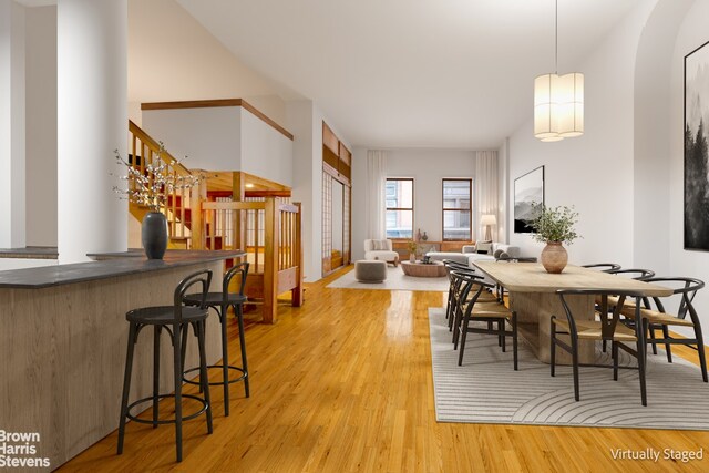 dining room featuring light wood-type flooring and bar area