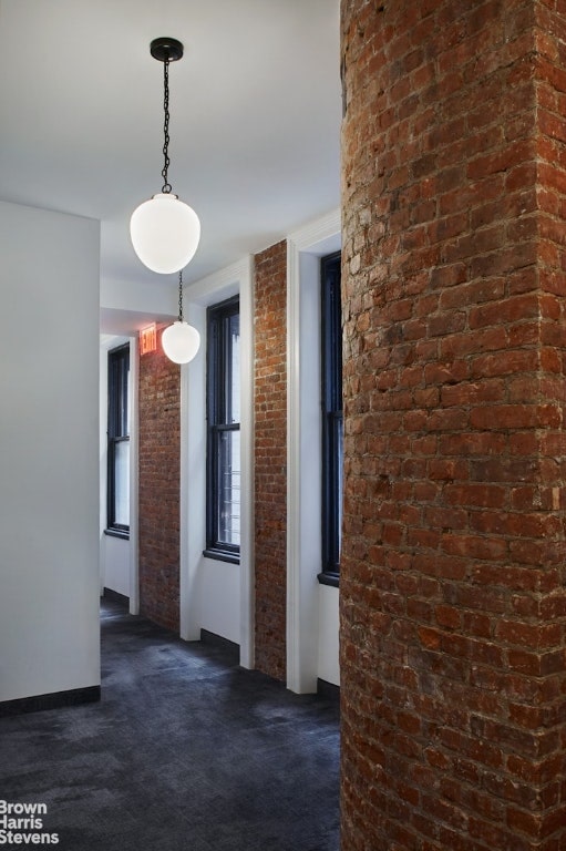 hallway featuring dark carpet