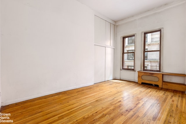 empty room with light hardwood / wood-style floors