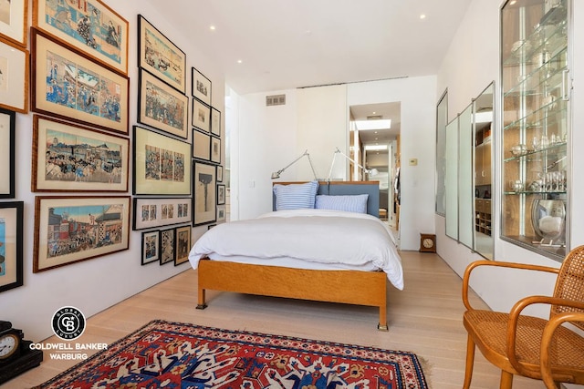 bedroom featuring visible vents and light wood-style floors