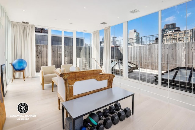 sunroom / solarium featuring a view of city and visible vents