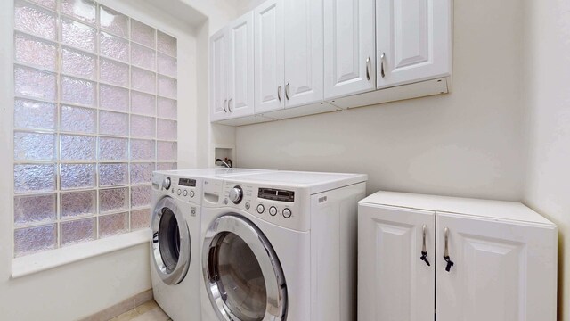 563 W 182nd St, New York City, NY 10033 - laundry area featuring cabinet space and washing machine and clothes dryer