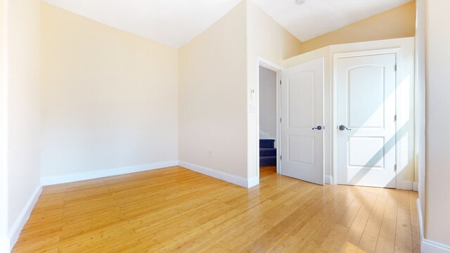 563 W 182nd St, New York City, NY 10033 - spare room featuring light wood-style flooring, baseboards, and lofted ceiling