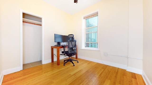 living room featuring ceiling fan, hardwood / wood-style flooring, built in features, and a wall mounted AC