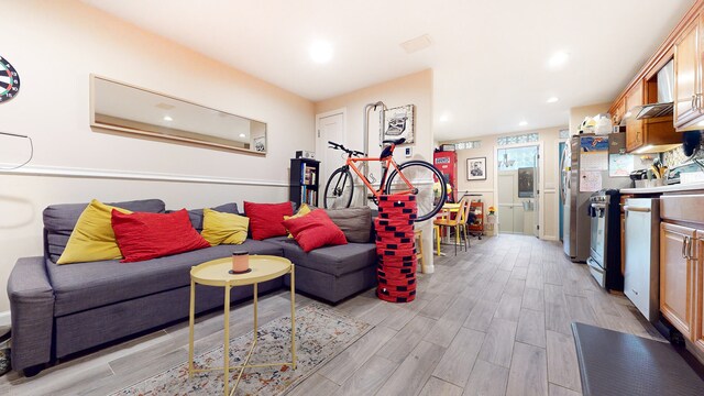 563 W 182nd St, New York City, NY 10033 - living area with light wood-style floors and recessed lighting