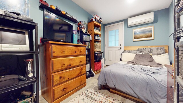 563 W 182nd St, New York City, NY 10033 - bedroom featuring a wall mounted air conditioner and wood finished floors