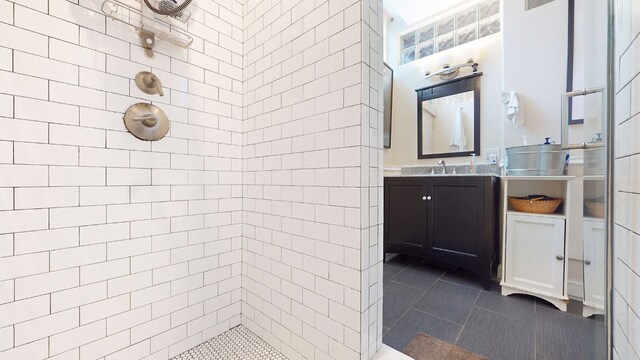 kitchen featuring dark stone countertops, appliances with stainless steel finishes, light hardwood / wood-style floors, and backsplash