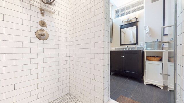 563 W 182nd St, New York City, NY 10033 - bathroom featuring tiled shower, vanity, and tile patterned flooring