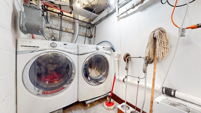 563 W 182nd St, New York City, NY 10033 - washroom featuring washer and dryer and wood finished floors