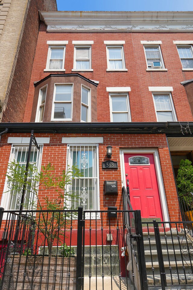 563 W 182nd St, New York City, NY 10033 - view of front of home with brick siding and a fenced front yard