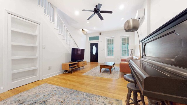 unfurnished room featuring wood-type flooring and an AC wall unit