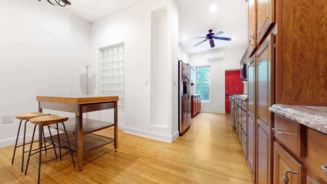 spare room featuring lofted ceiling and light hardwood / wood-style flooring