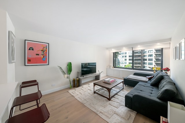 living room featuring light wood-type flooring and baseboards