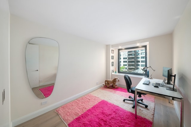 home office with wood finished floors and baseboards