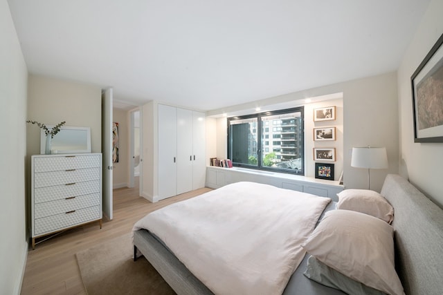 bedroom featuring light wood-style flooring