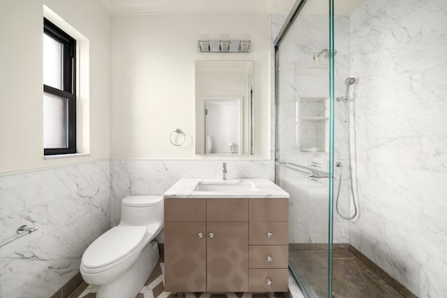 bathroom featuring toilet, tile walls, a shower with door, and vanity