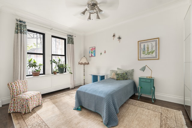 bedroom with ceiling fan, wood-type flooring, and crown molding