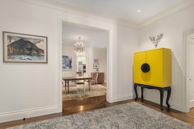 interior space featuring crown molding, hardwood / wood-style floors, and a notable chandelier