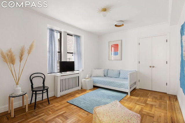 living area with light parquet flooring and radiator