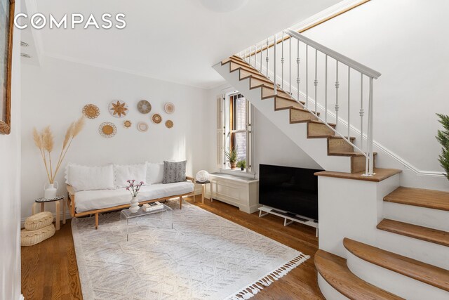 living room with stairway and wood finished floors