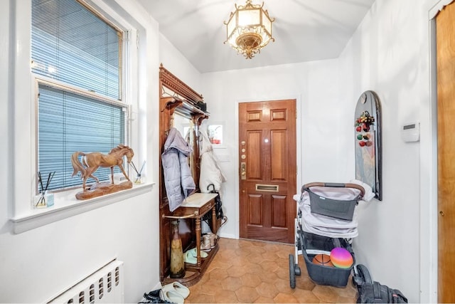 mudroom featuring radiator heating unit and light tile patterned flooring