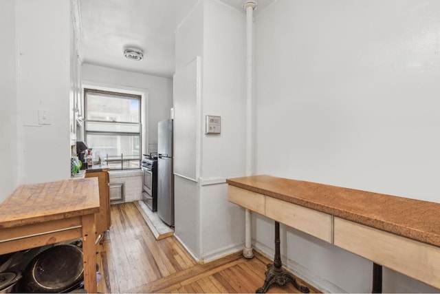 kitchen featuring wood-type flooring and appliances with stainless steel finishes