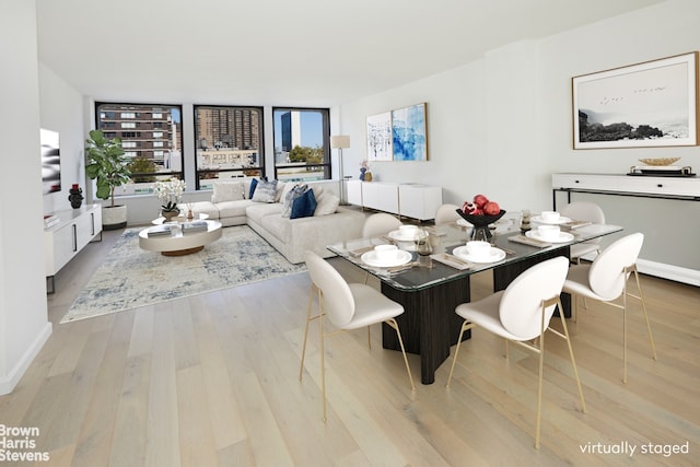 dining space with plenty of natural light and light hardwood / wood-style flooring