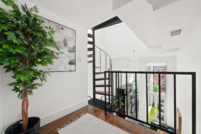 hall with baseboards, stairs, visible vents, and dark wood finished floors