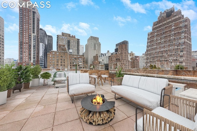 view of patio / terrace featuring an outdoor fire pit