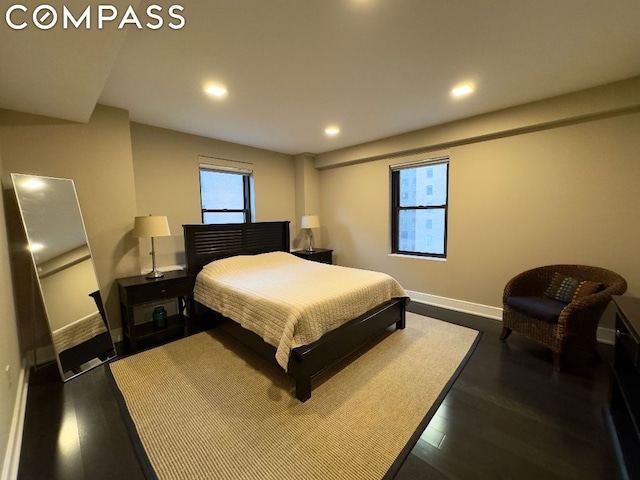 bedroom with dark hardwood / wood-style flooring