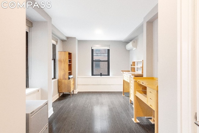 bathroom with hardwood / wood-style flooring and a wall mounted air conditioner