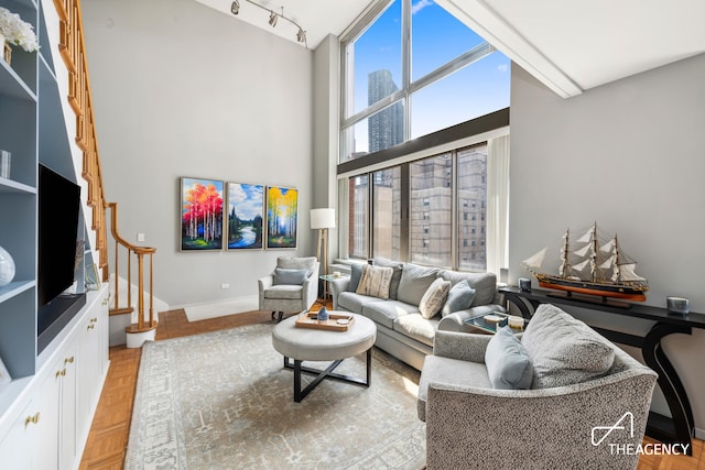 161 W 61st St Unit 16A, New York City, NY 10023 - living room featuring a high ceiling, baseboards, and a view of city