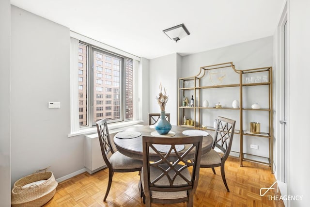 dining room featuring light parquet floors