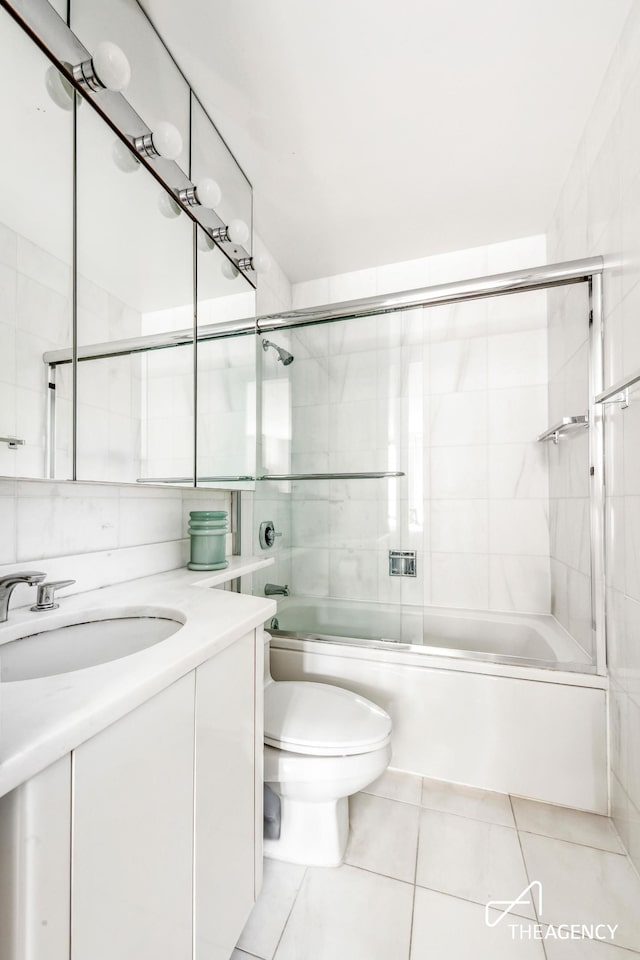 161 W 61st St Unit 16A, New York City, NY 10023 - bathroom with vanity, tile patterned flooring, toilet, and enclosed tub / shower combo