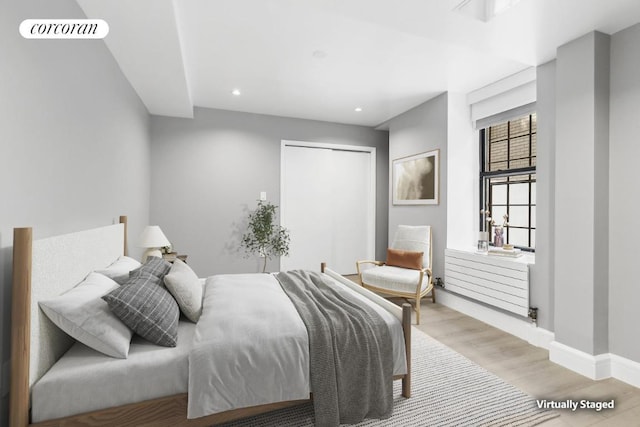 bedroom featuring a closet and light hardwood / wood-style flooring